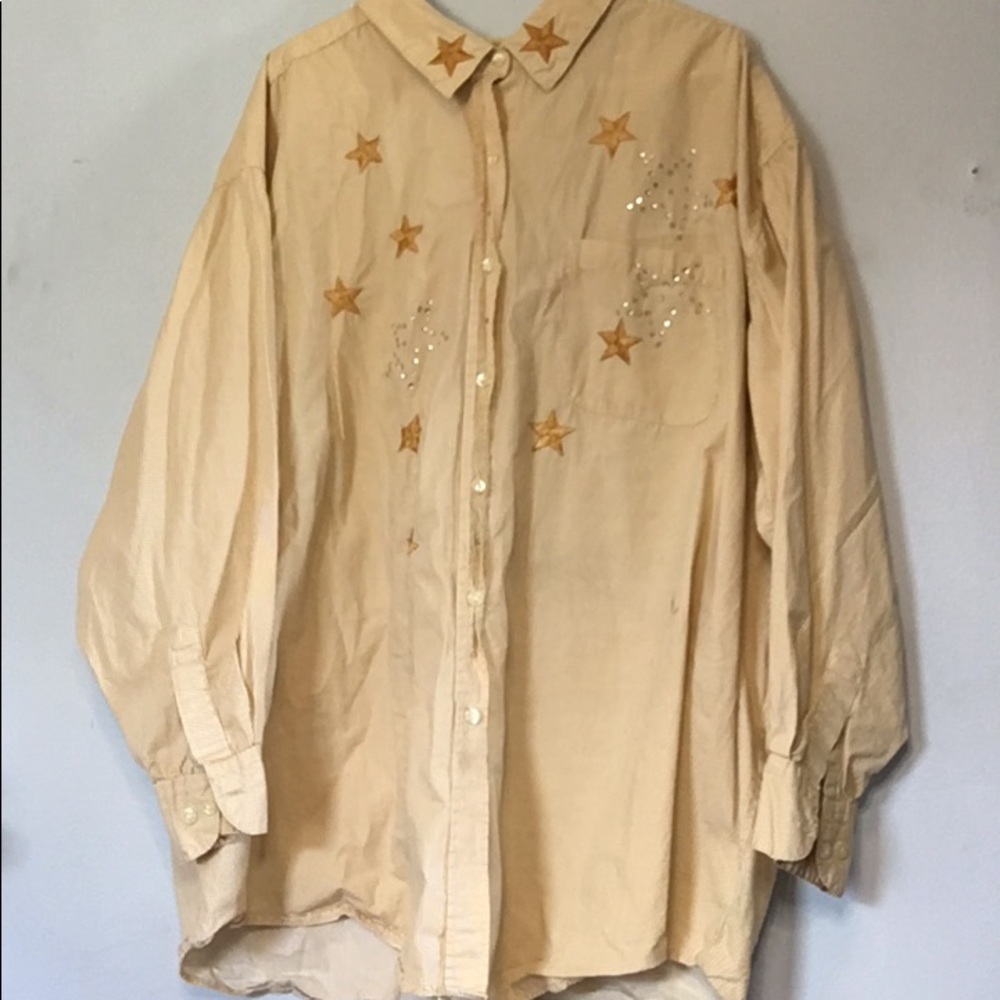 This is a yellow collard shirt with stars and gems